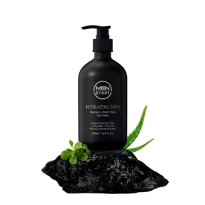 Men Story Hydrating 3-in-1 product featuring black bottle with pump on dark rock and fresh green leaves.